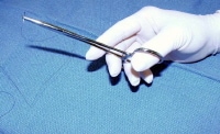 The needle holder is held through the loops betwee